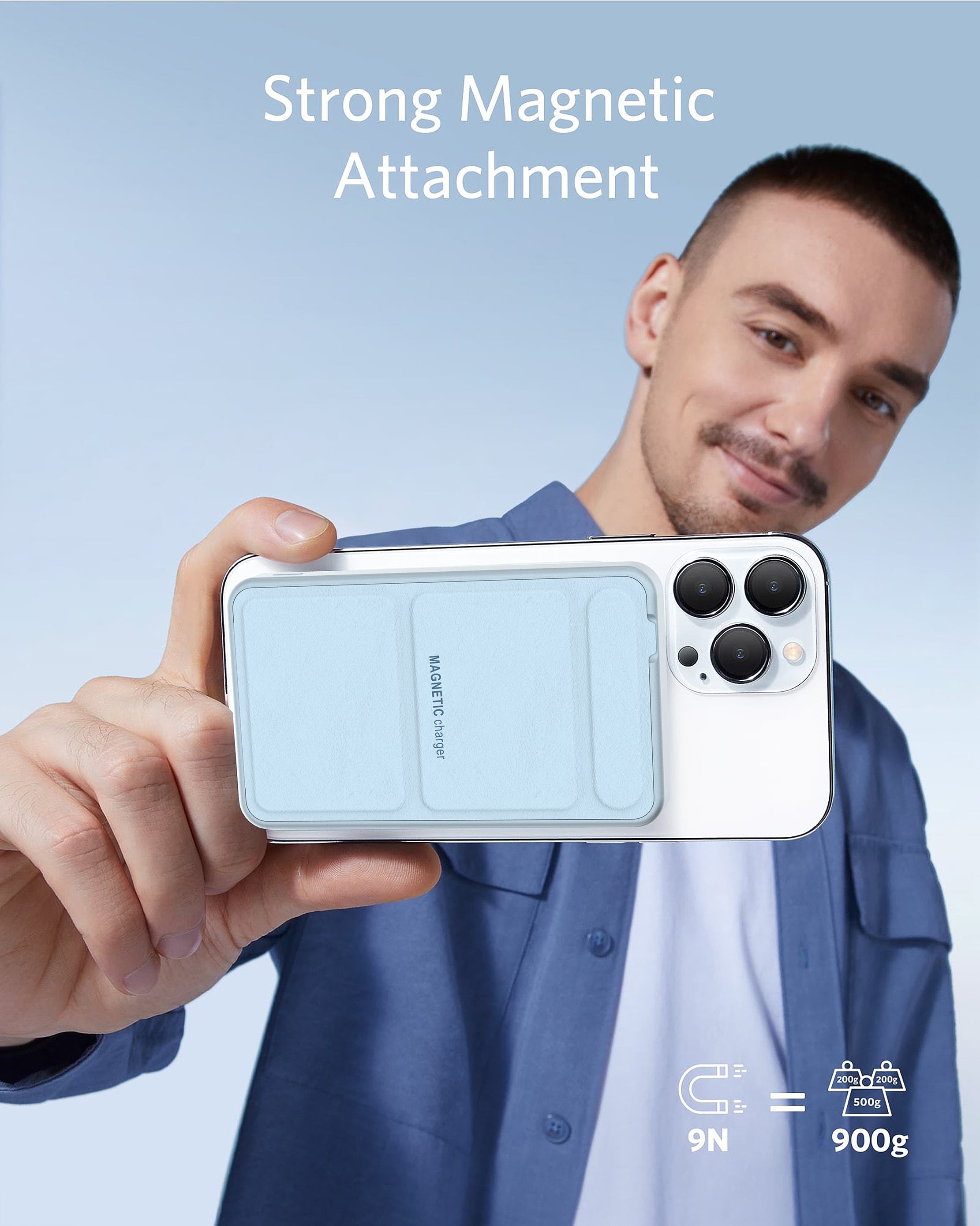 Man holding a white smartphone with a light blue magnetic charger attached to the back.